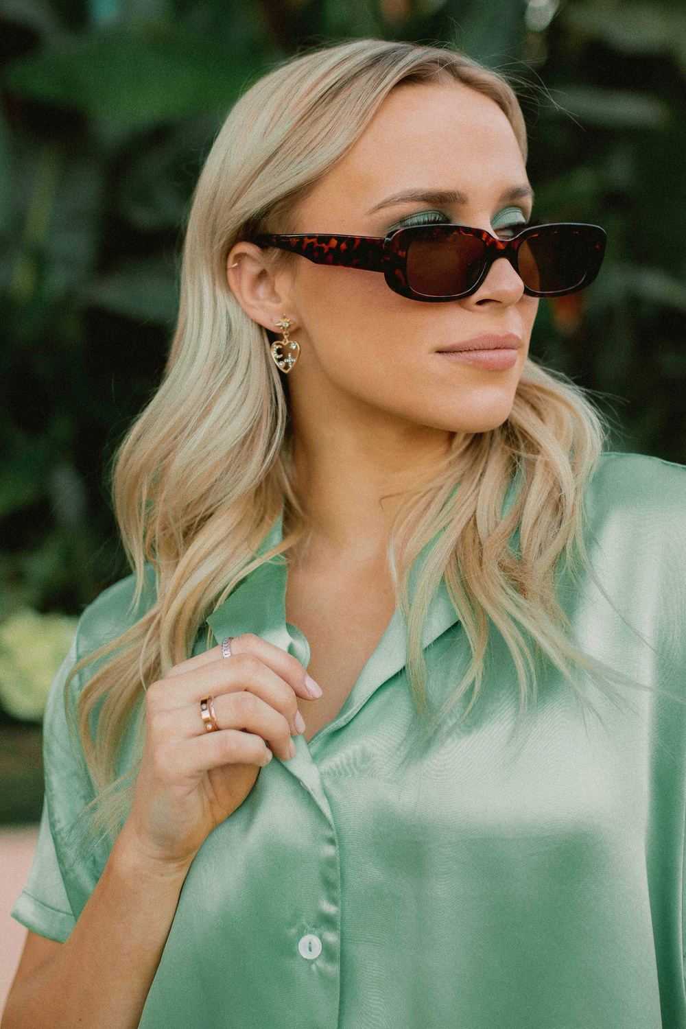 Woman on Green Satin Polo Shirt Wearing Sunglasses