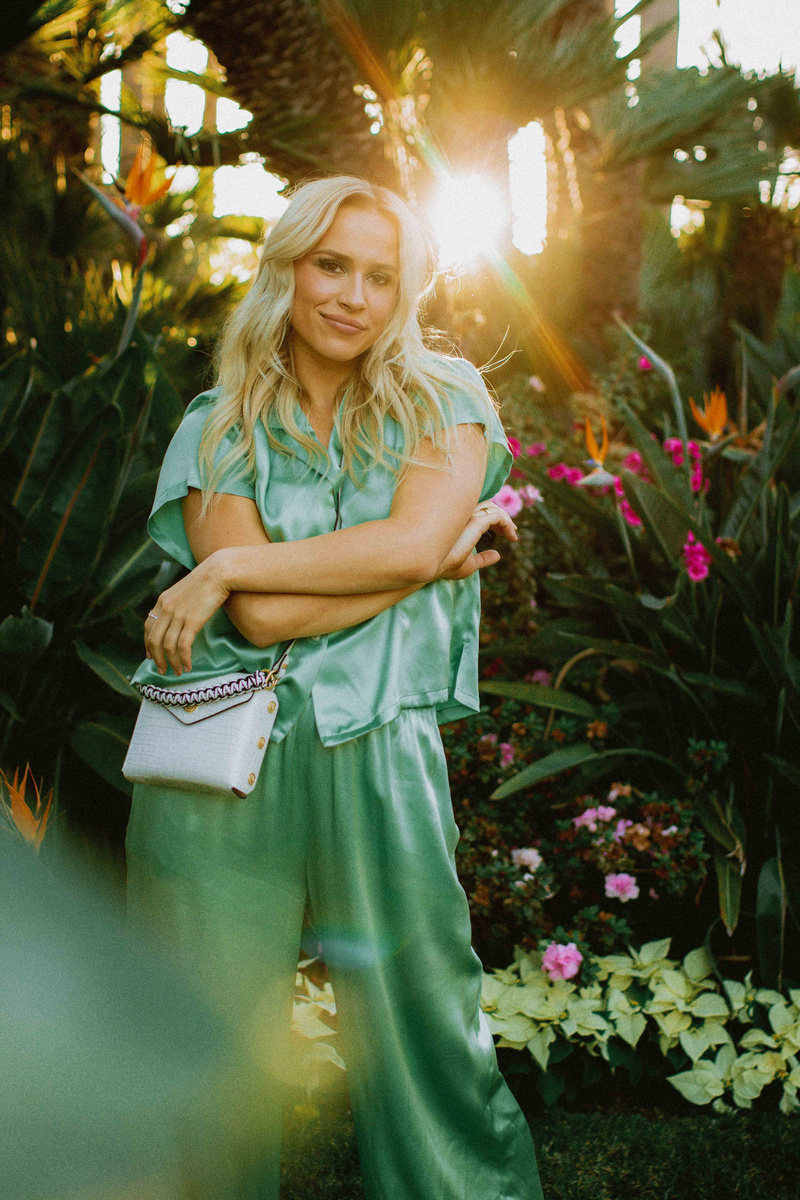 Woman Wearing Green Satin Clothes with Plants  on the Background